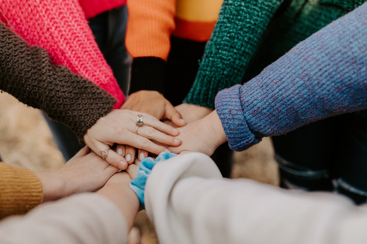 Community members joining hands together