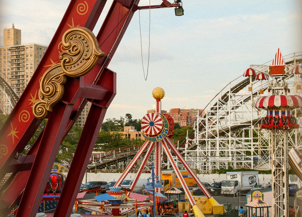 Amusement park rides with a roller coaster in the background