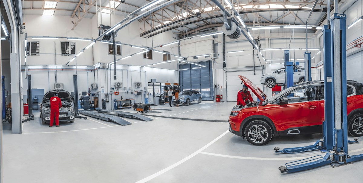 Mechanics working on cars in an automotive repair shop