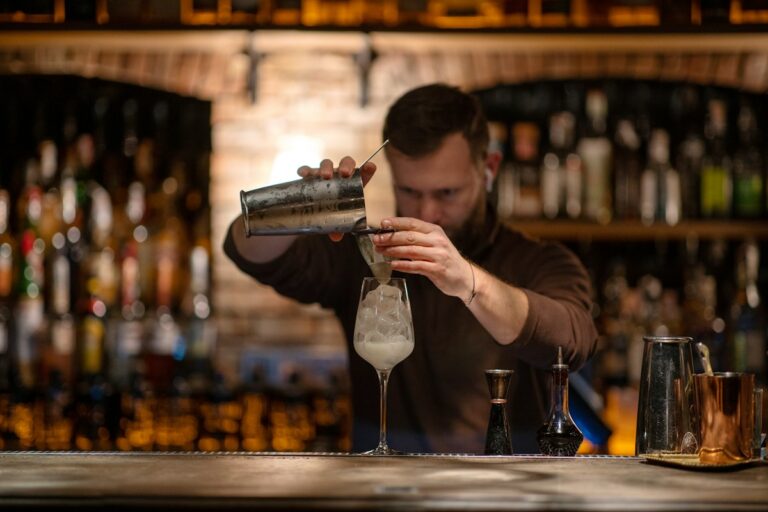 A bartender making a drink at a bar