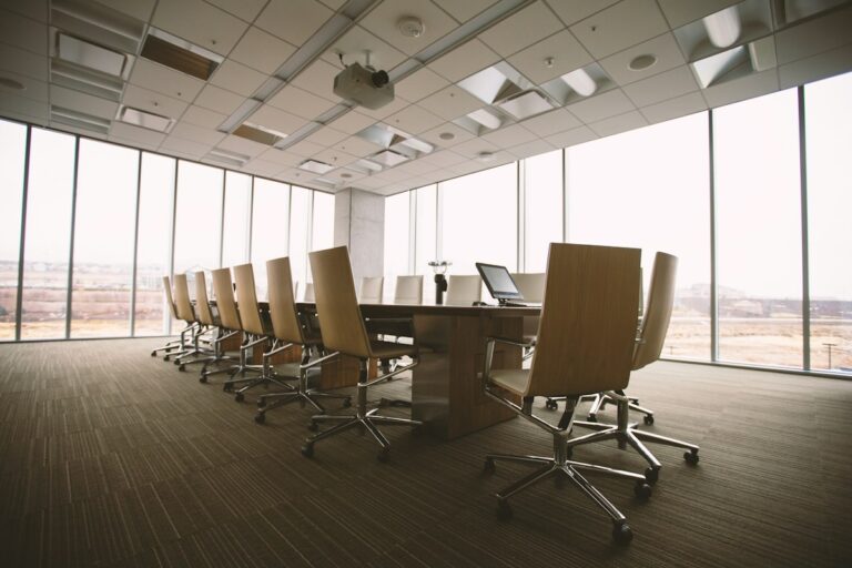 Corporate boardroom with a wooden conference table and chairs