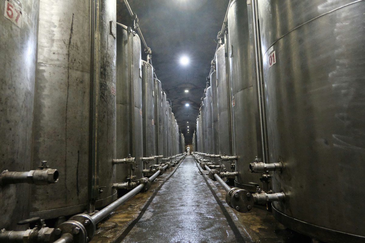 Stainless steel brewery tanks in a long hall