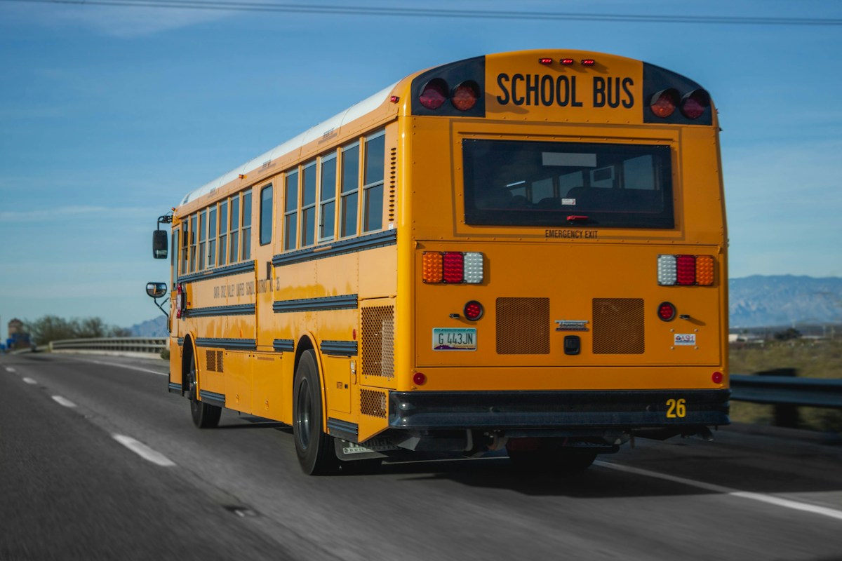 Yellow school bus on the road during daytime