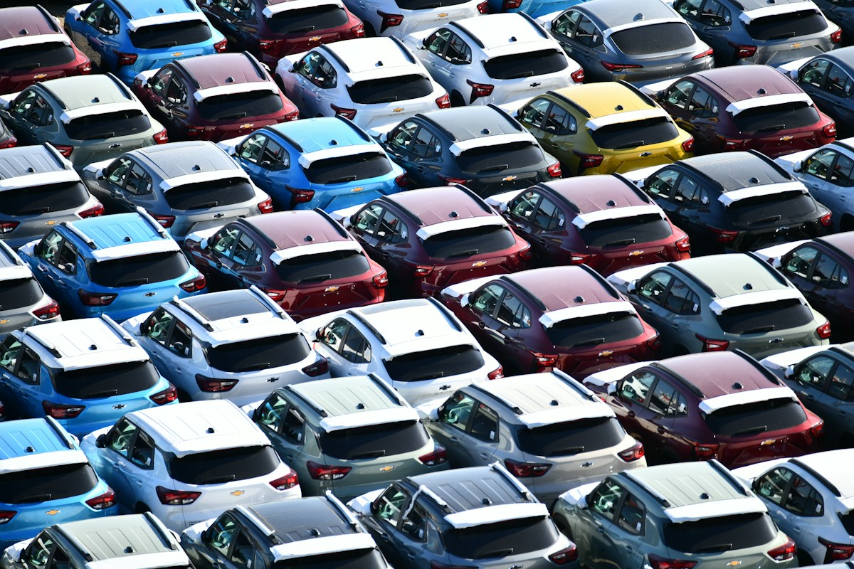 Rows of new cars parked on a dealership lot