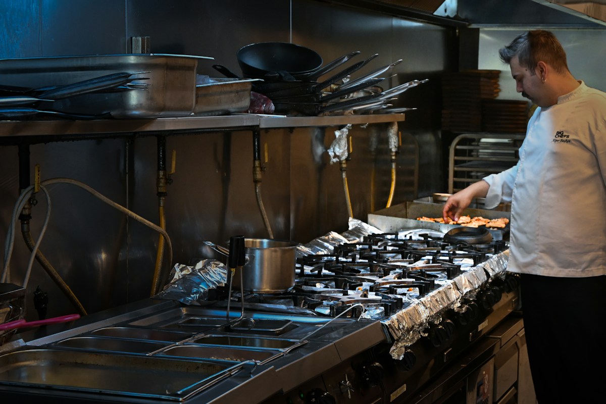 A chef cooking in a commercial kitchen