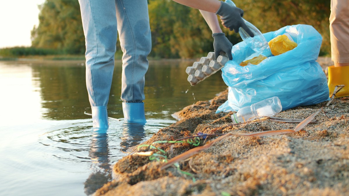 Crew cleaning up waste from a riverbank