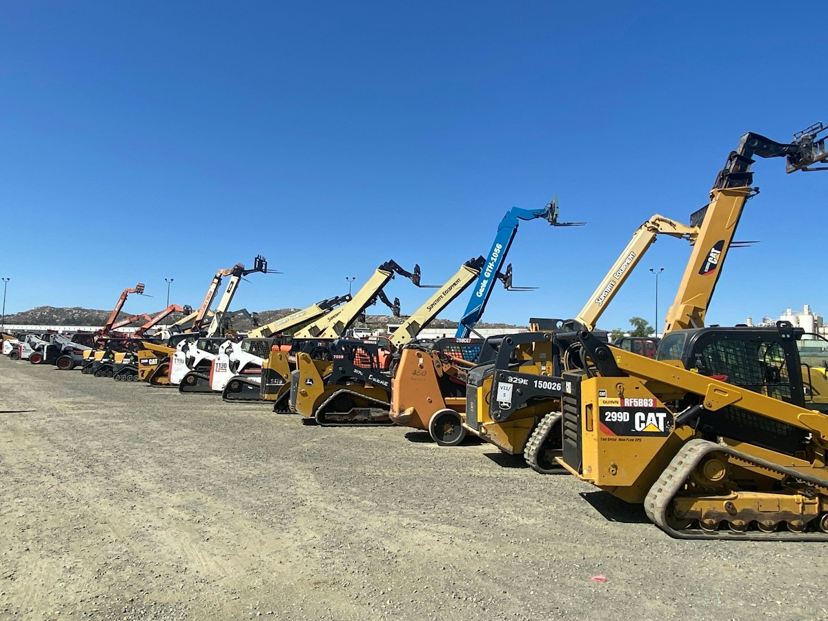 A group of yellow heavy construction equipment