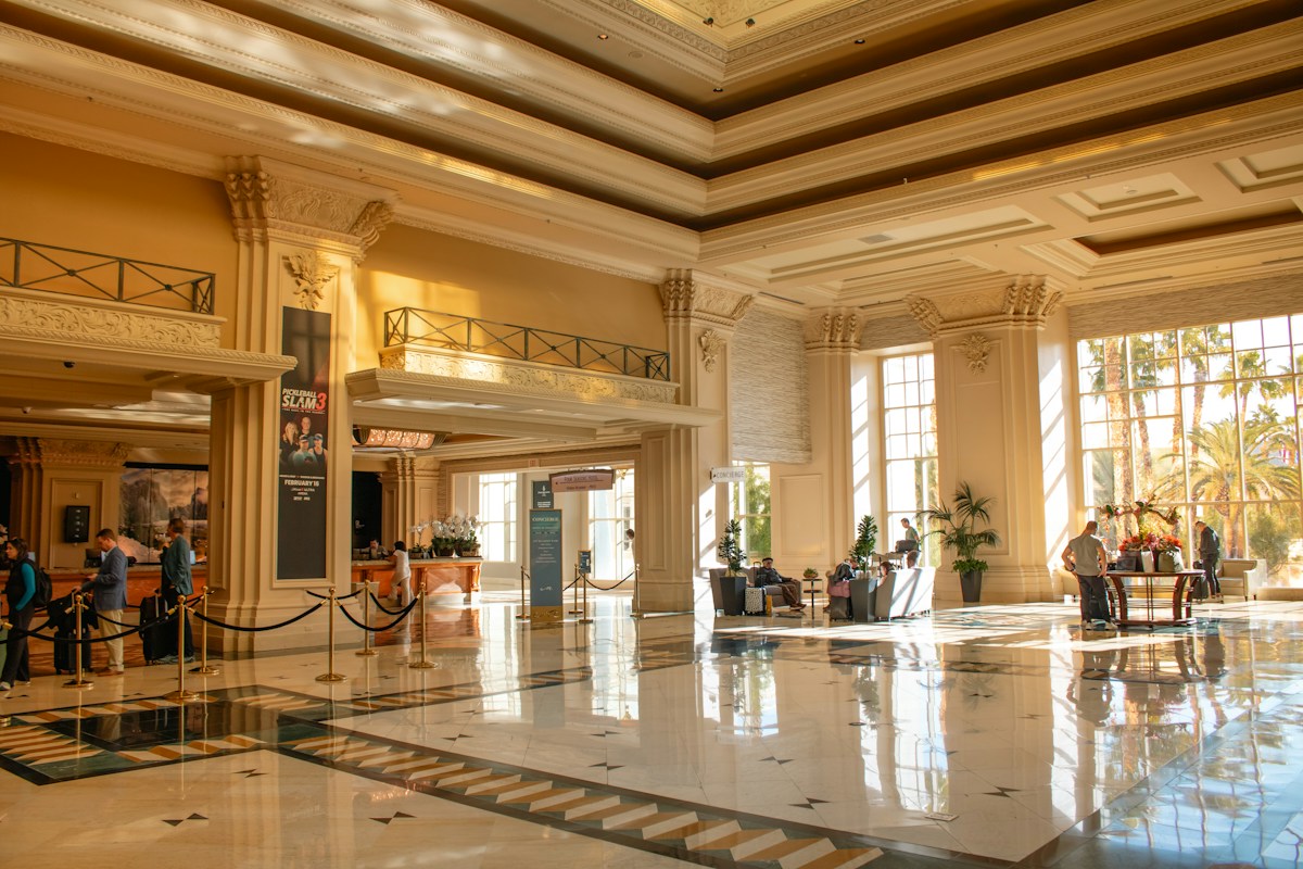 A grand hotel lobby filled with sunlight