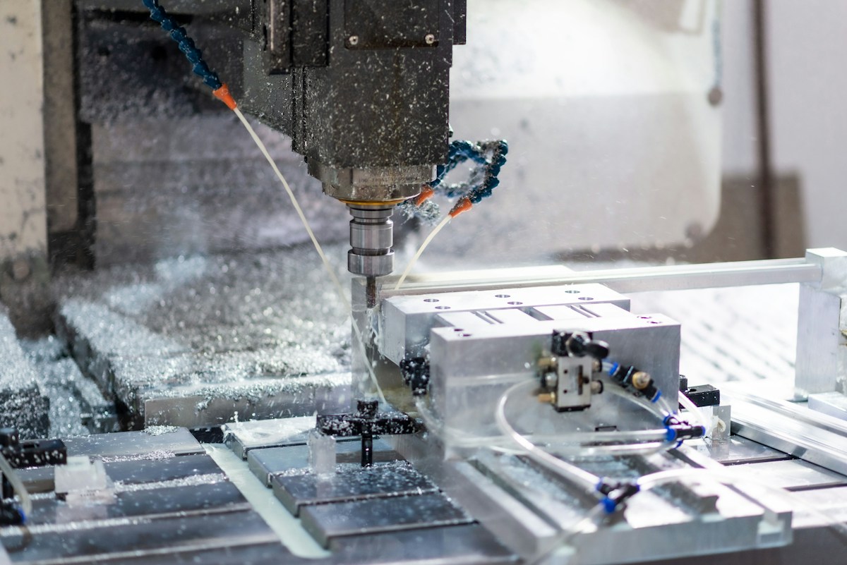A CNC machine cutting a piece of metal