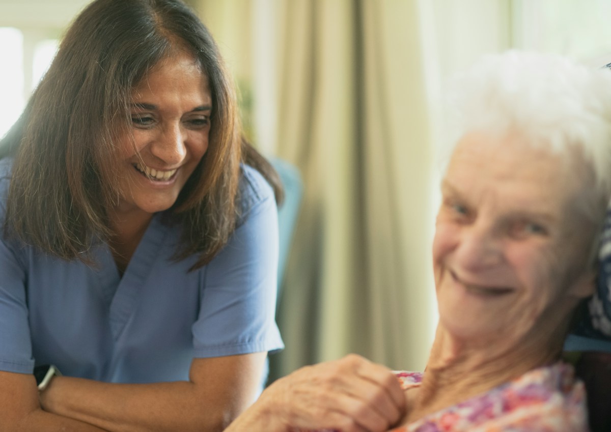 Nurse caring for an elderly patient at home