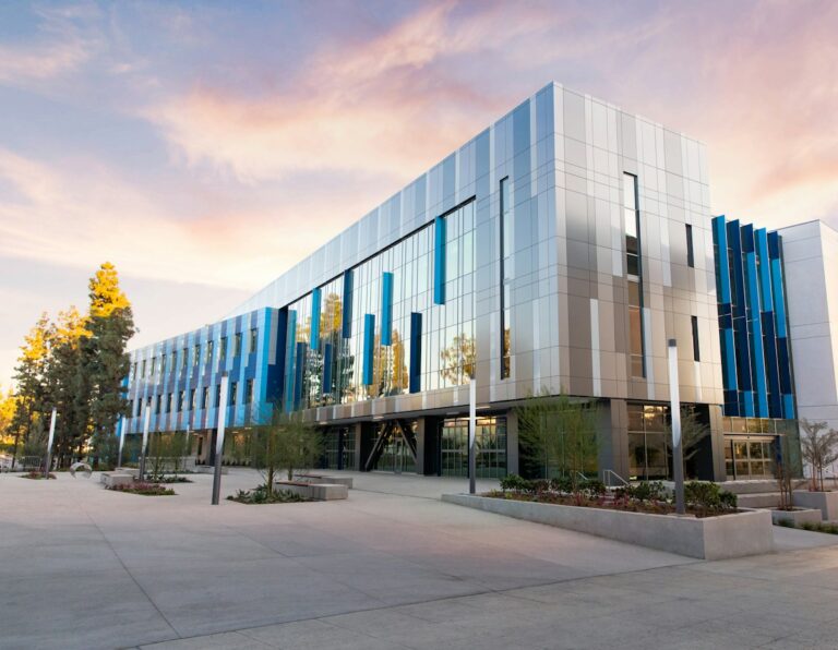 A modern office building with blue and silver panels