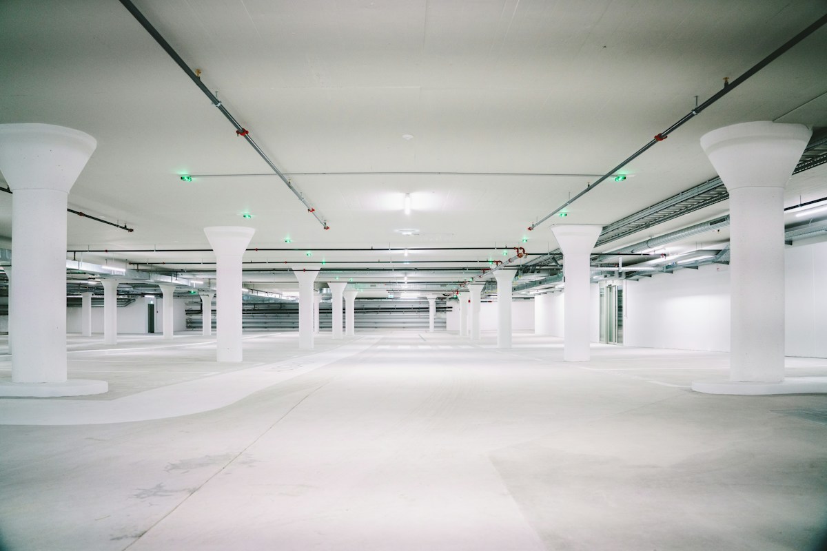 Empty concrete parking garage with pillars