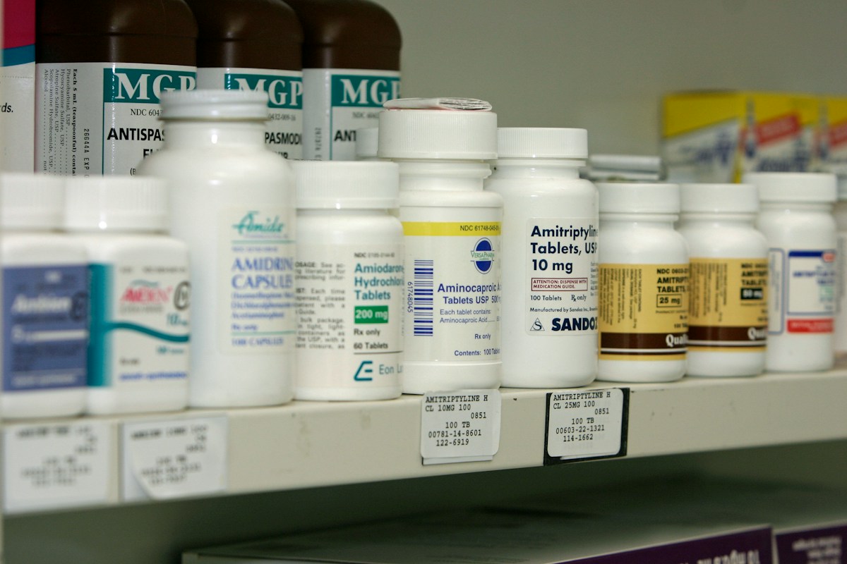 Pharmacy shelves stocked with medicine bottles