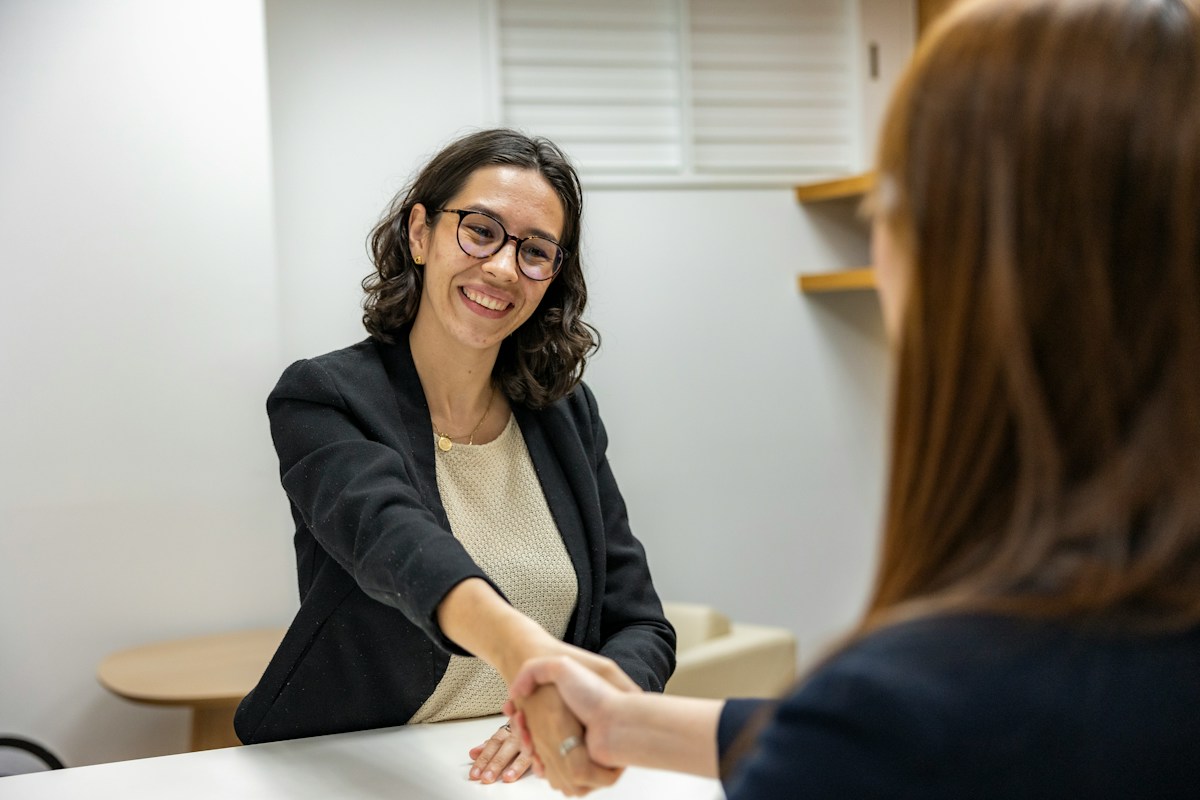 Two women shaking hands at a job interview